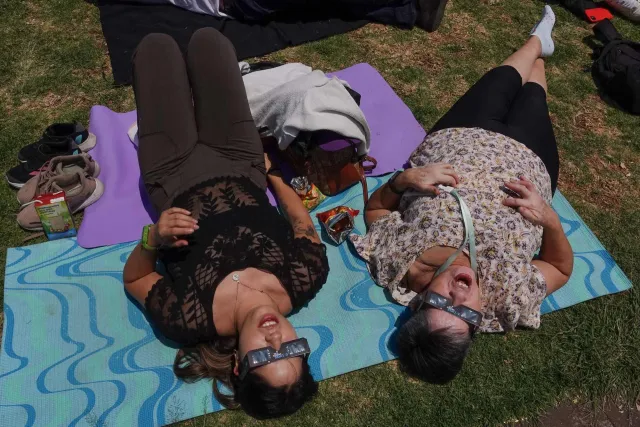 Mujeres ven el eclipse desde Ciudad Universitaria