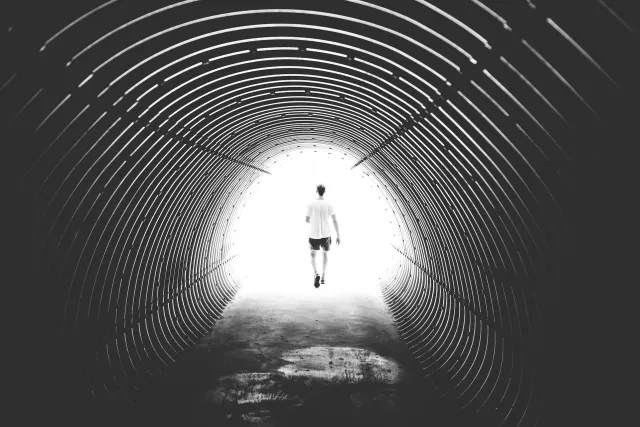 Persona al final de un túnel de luz